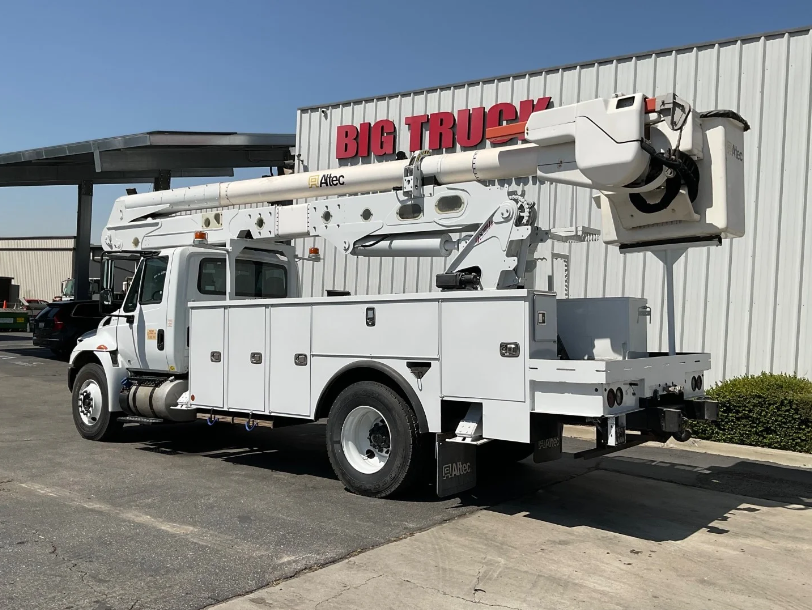 The bucket truck is parked on the street.